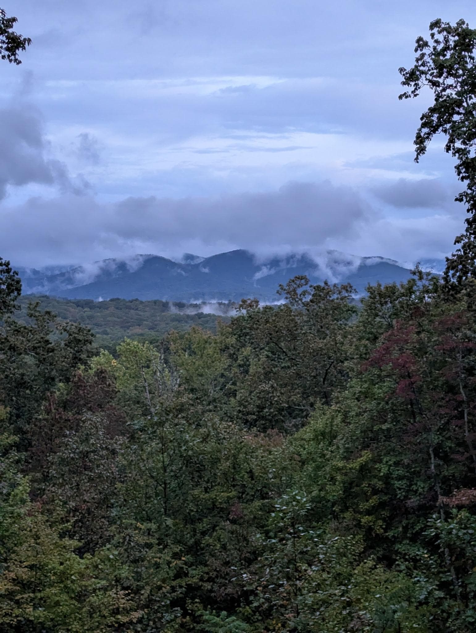 Clouds roll in quick and cover the mountains