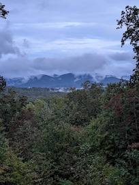 Clouds roll in quick and cover the mountains