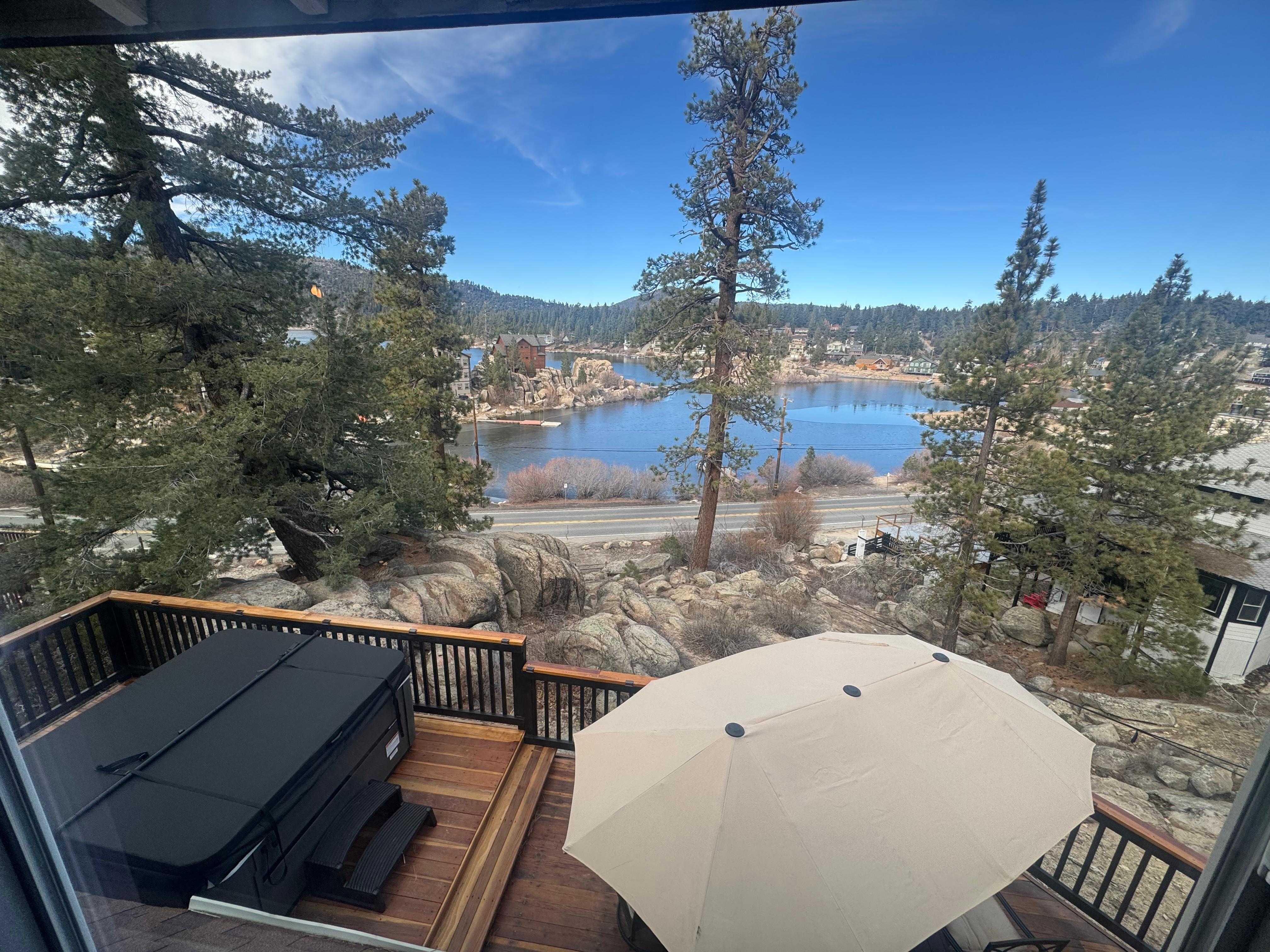 Beautiful view from our bedroom overlooking the deck with hot tub and Big Bear Lake. 
