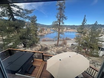 Beautiful view from our bedroom overlooking the deck with hot tub and Big Bear Lake.