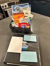 Welcome binder with additional information on things in the area. Basket with great maps, books, guides, simple snacks also.