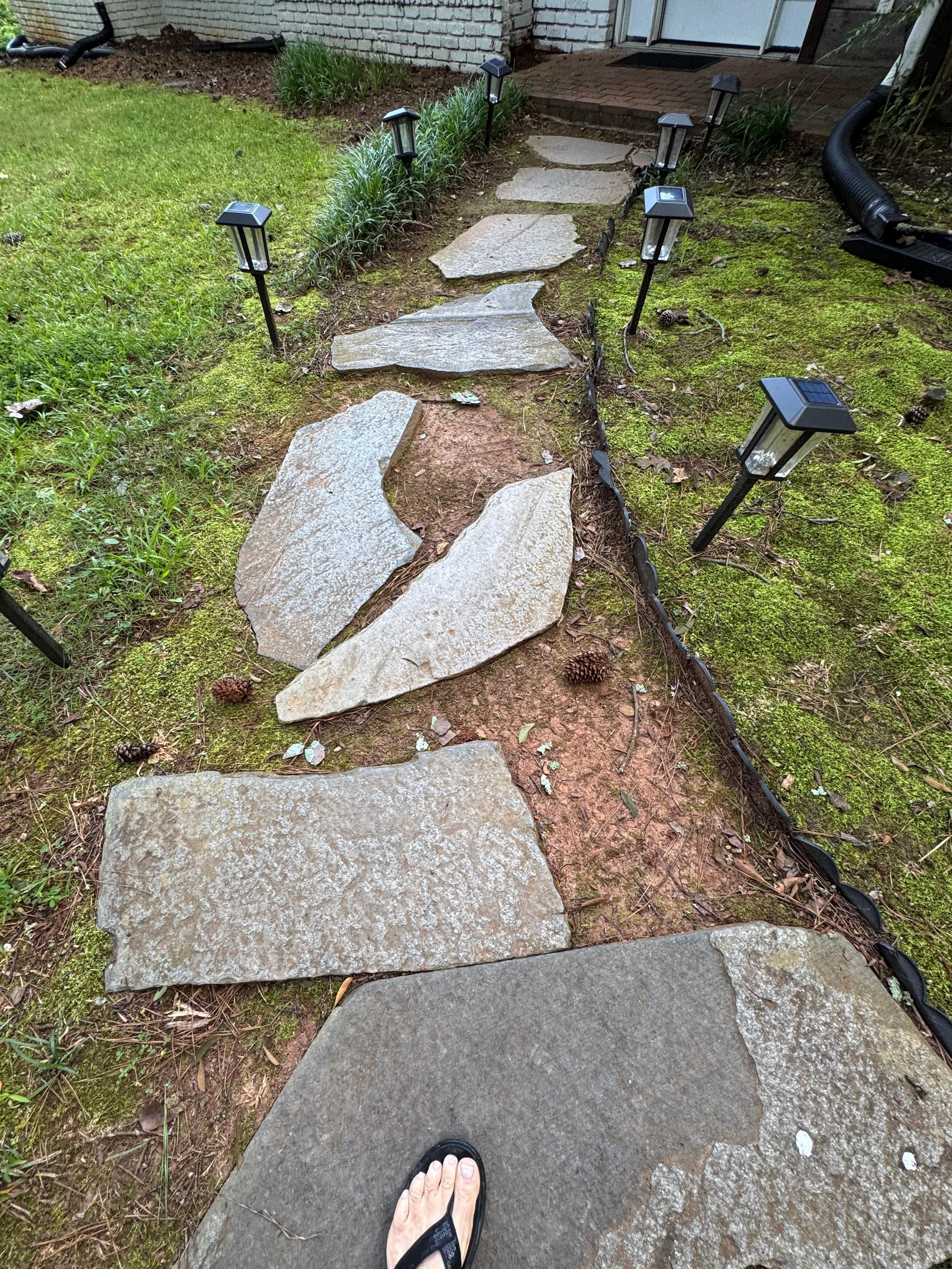 Uneven, wobbly insecure stepping stone front door walkway, spaced irregularly 
