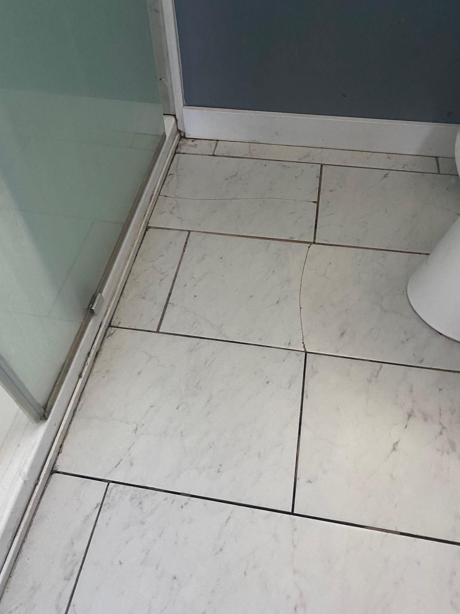Bath broken cracked tile and shower edge nasty dirty