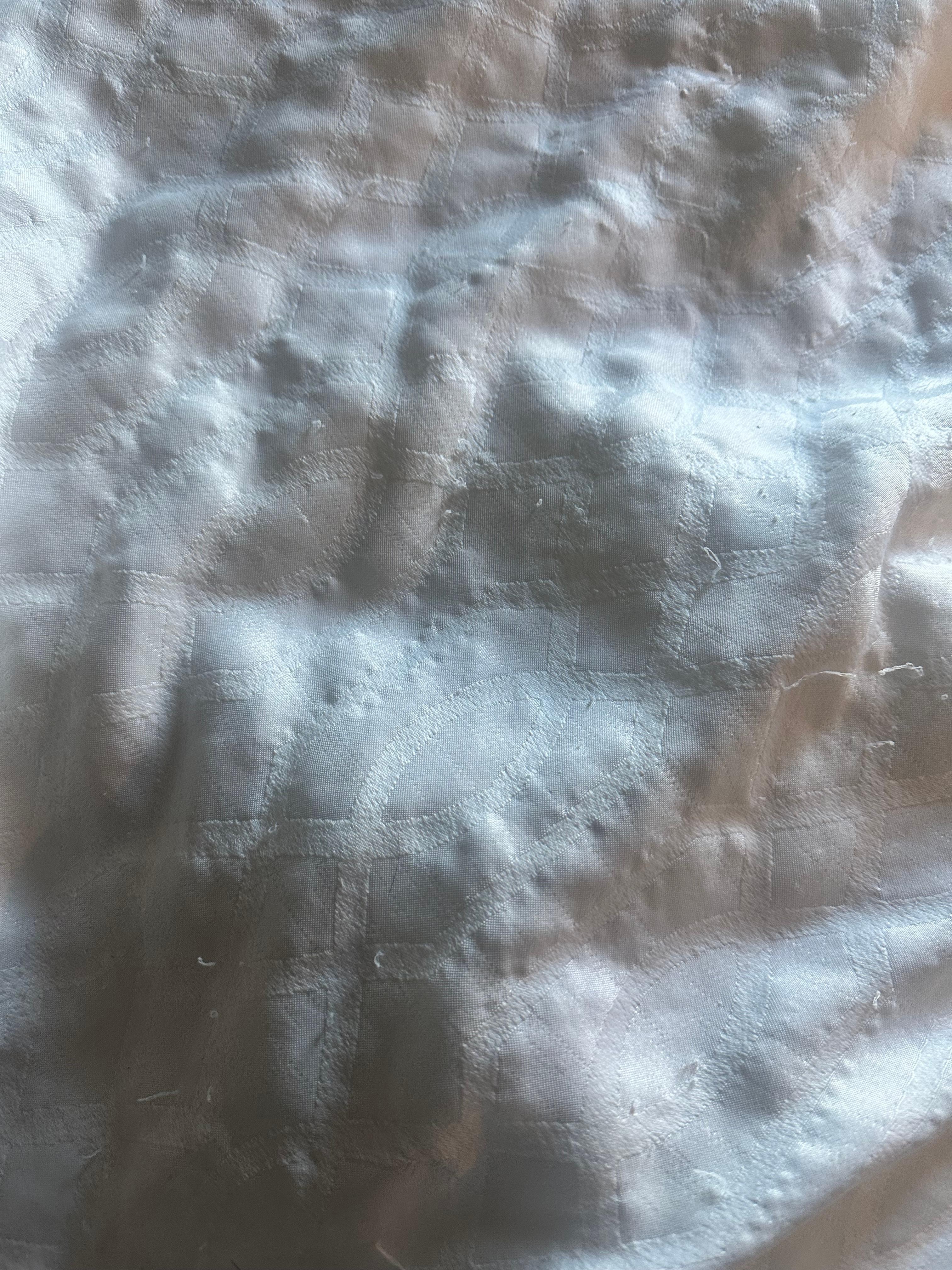 Stained bed coverlet 