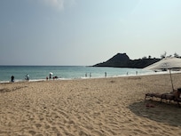 The beach across the street from the hotel, accessible by a path under the road.