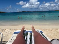 Sunbathing in beach next to condo