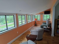 Living room area and deck just outside - facing the water.