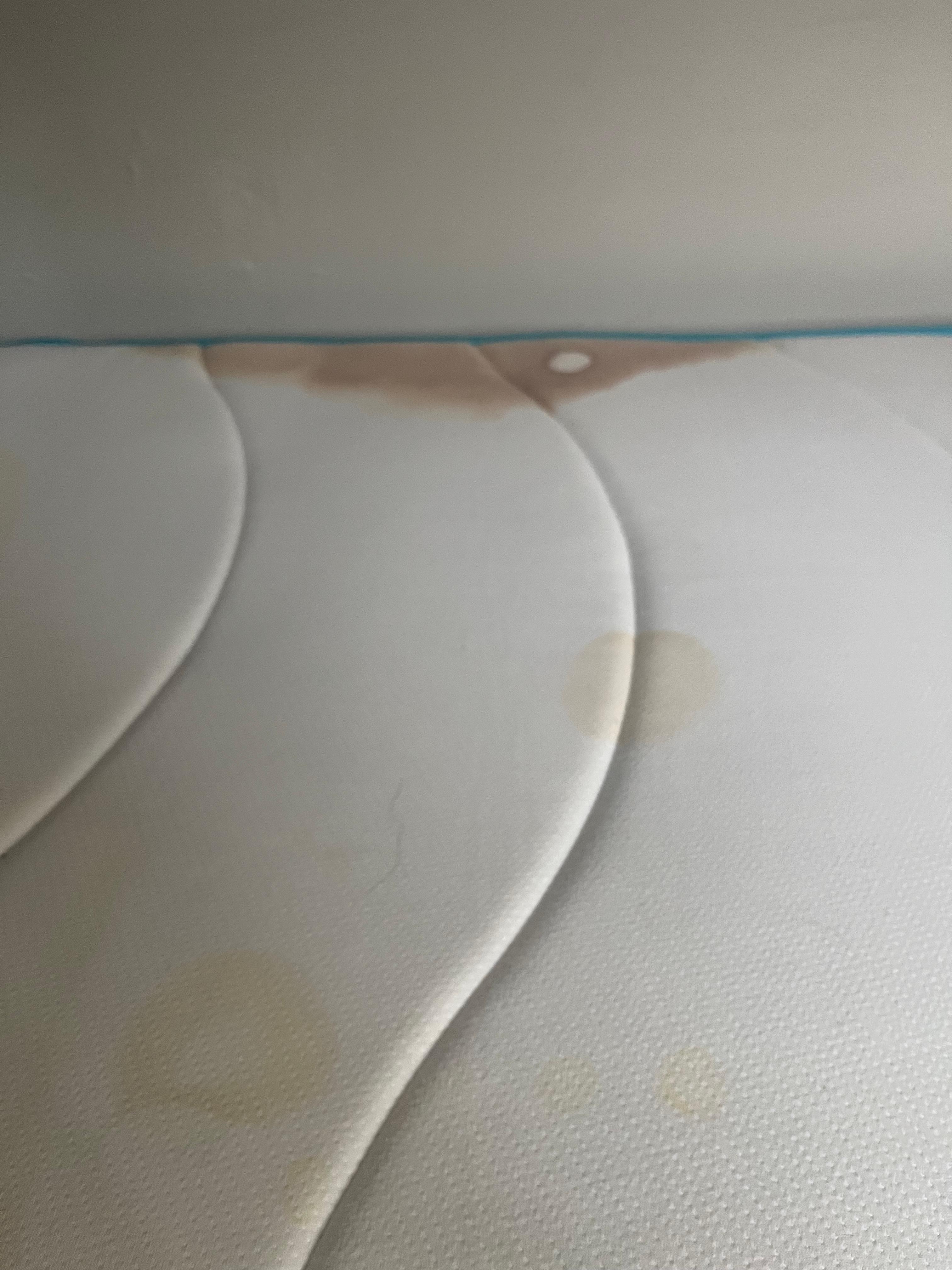 The grossly stained mattress I slept on without any mattress pad. 