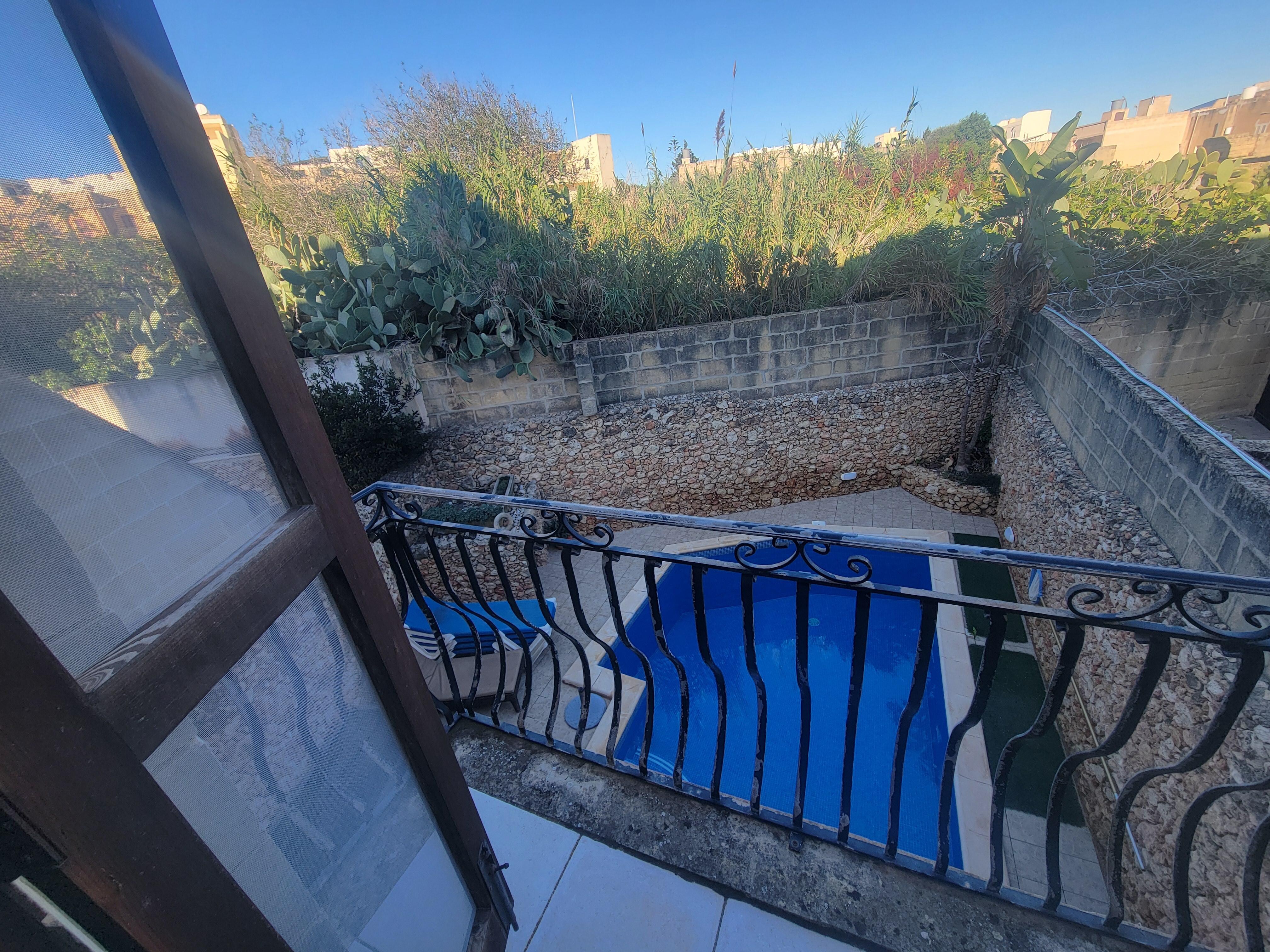Master bedroom balcony view of pool