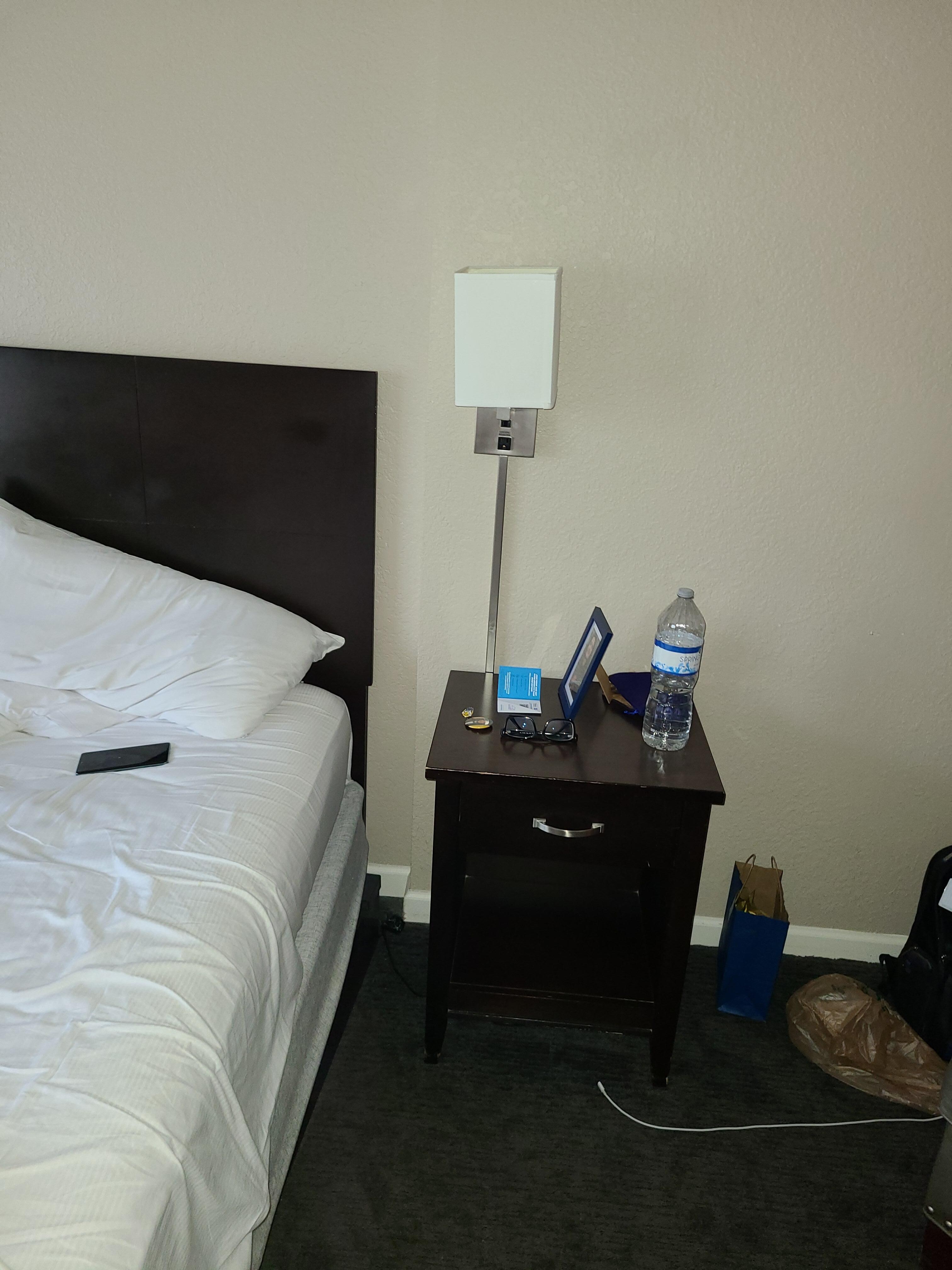 Loose lamp and metal rods sticking out of the bedframe