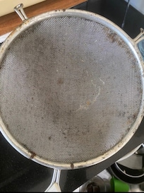 Rust and dirty colander found in kitchen cupboard