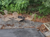 Close up of chairs and fire pit.