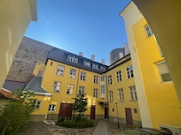 courtyard — apartment has the three windows on the secon floor, right side