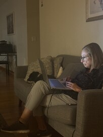 My wife enjoying TV & laptop.