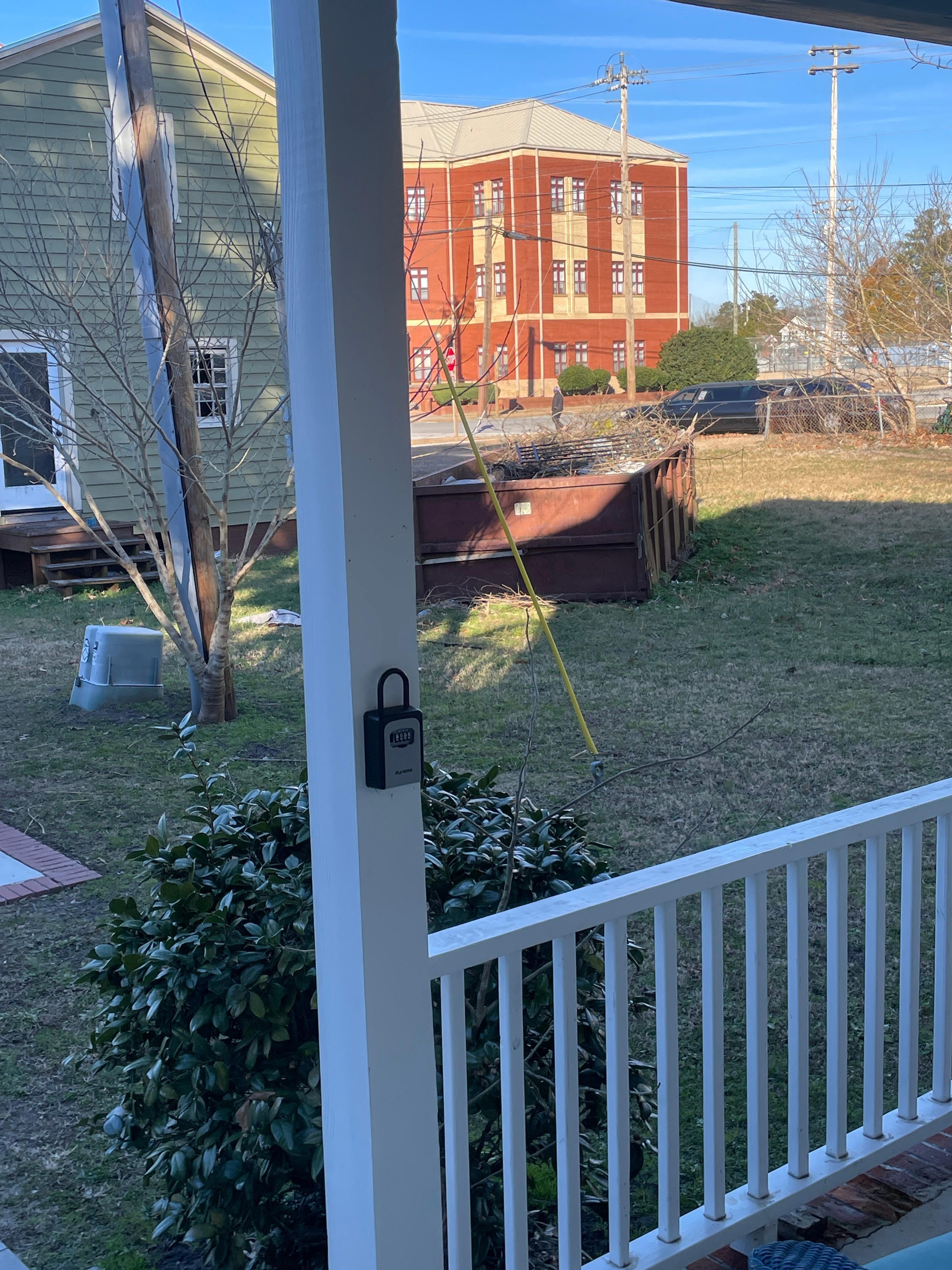 Industrial dumpster just a few feet from the driveway