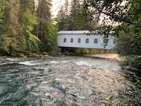 view of a covered bridge viewable from the deck of the house.
