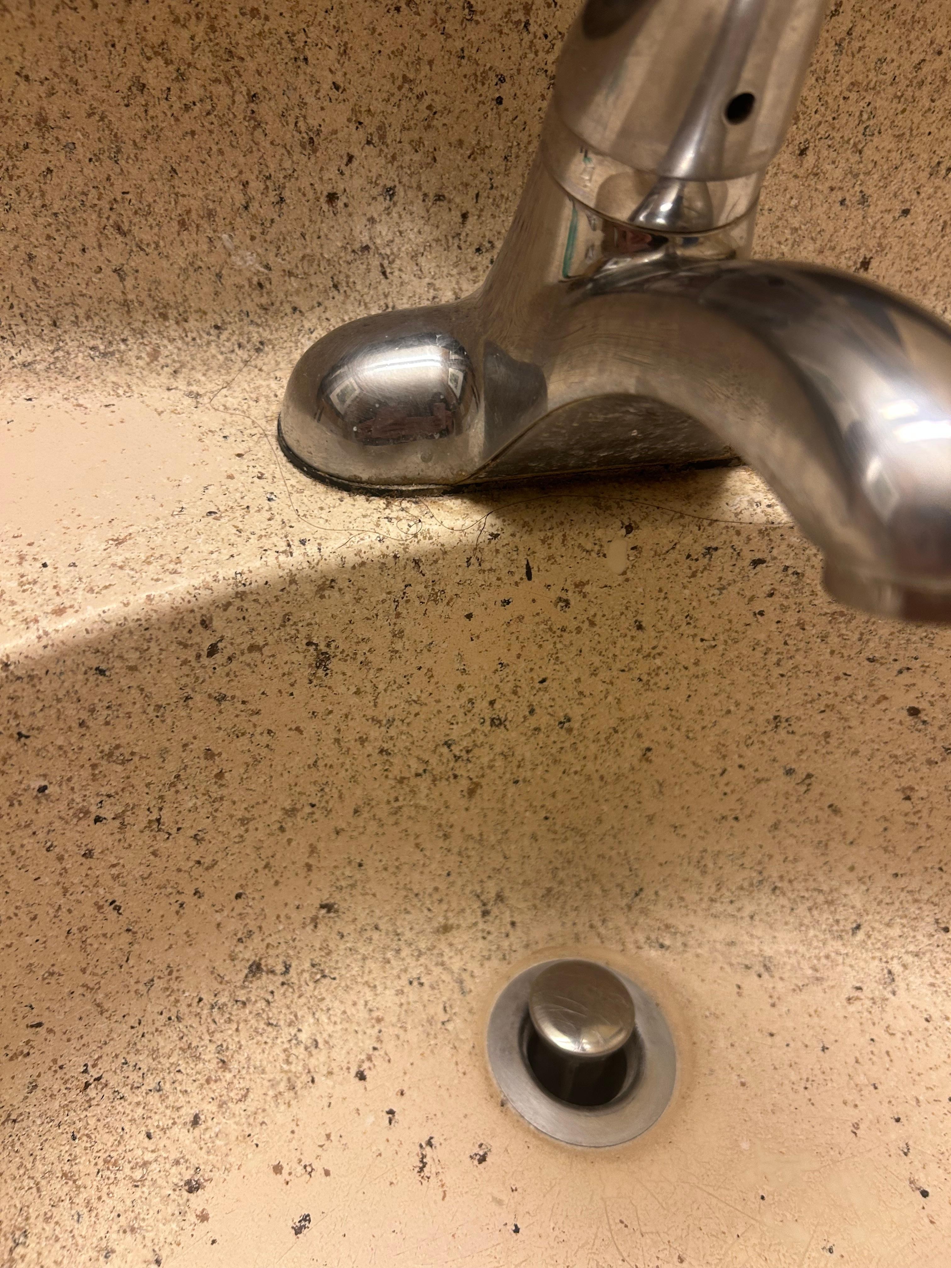 Bathroom sink, some else’s hair around the faucet 