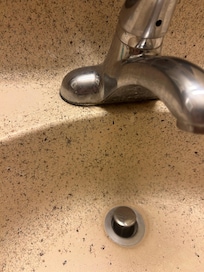 Bathroom sink, some else’s hair around the faucet