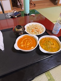 Room service—shrimp rice, butter chicken, and vegetable curry. It was all delicious!