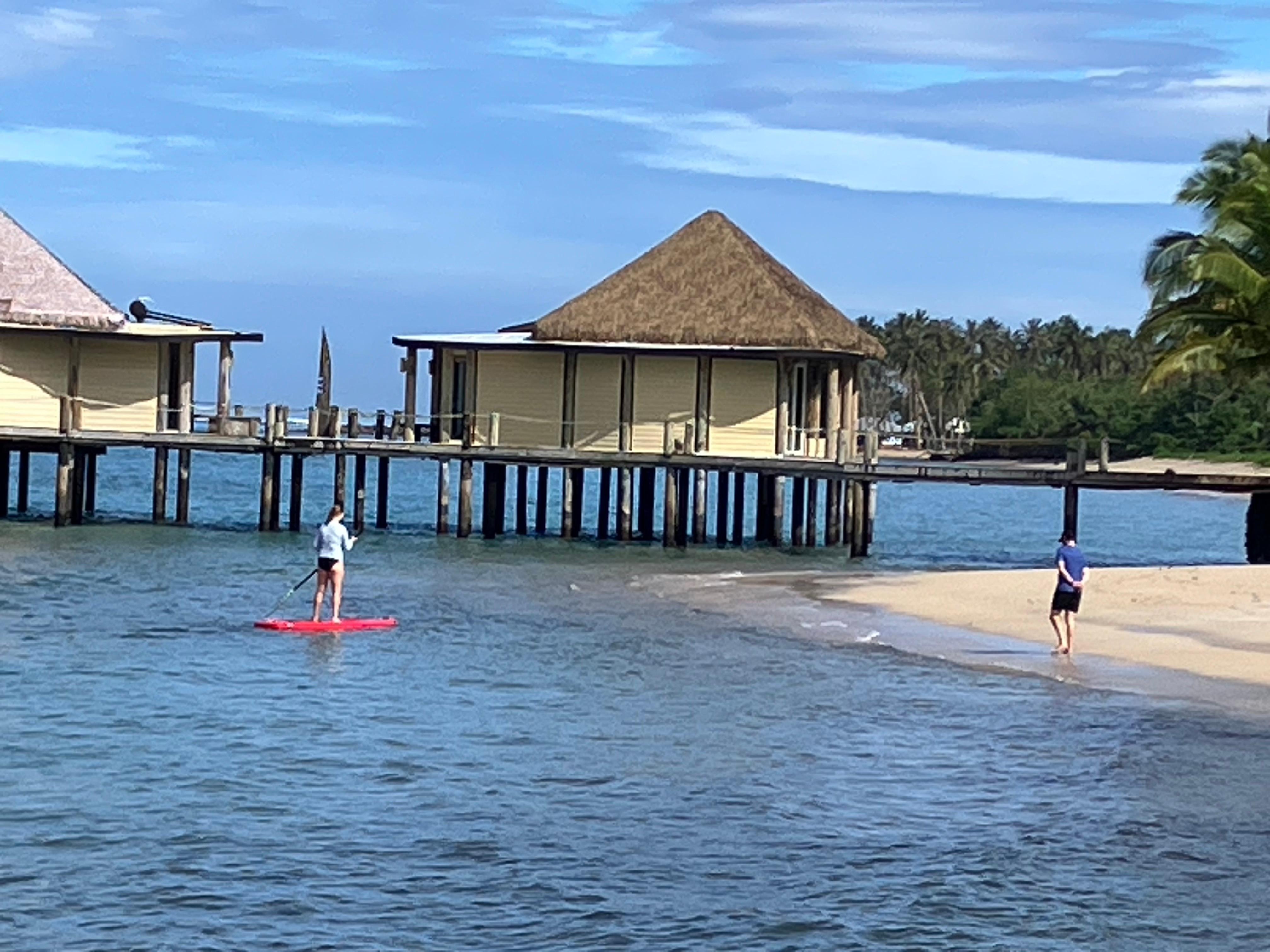Paddleboarding near the 'Over the beach fales '