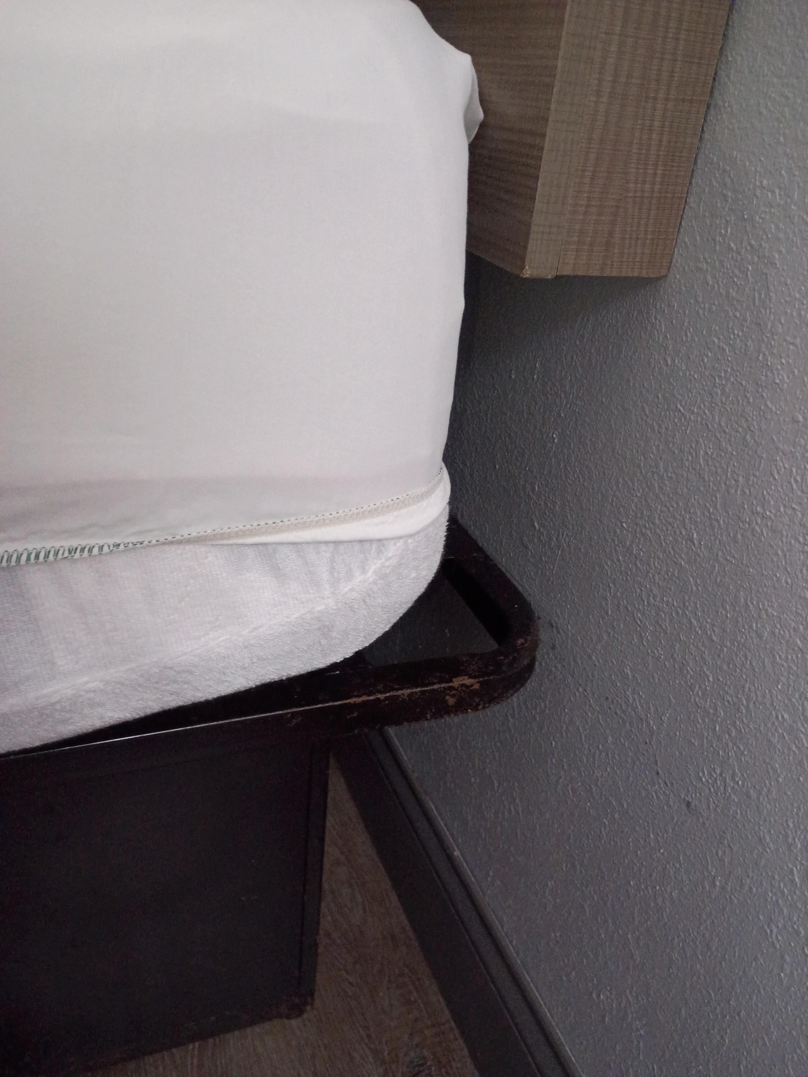 Some rusty signs on bed frame.  Normal size fitted sheet on deep mattress.