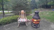 Attractive front patio with views of the wooded grounds, grill and fire pit provided.