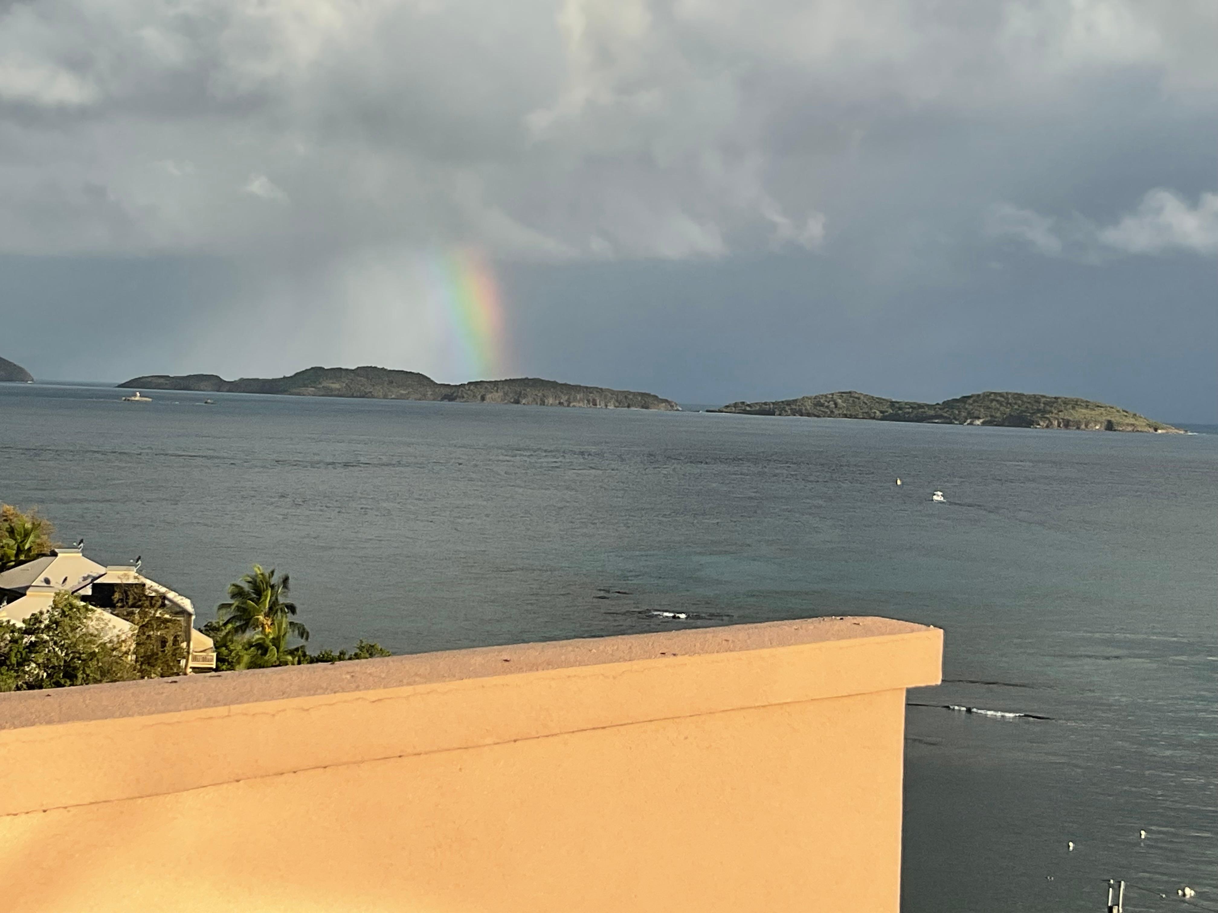 Overcast day with a rainbow viewd from balcony. 