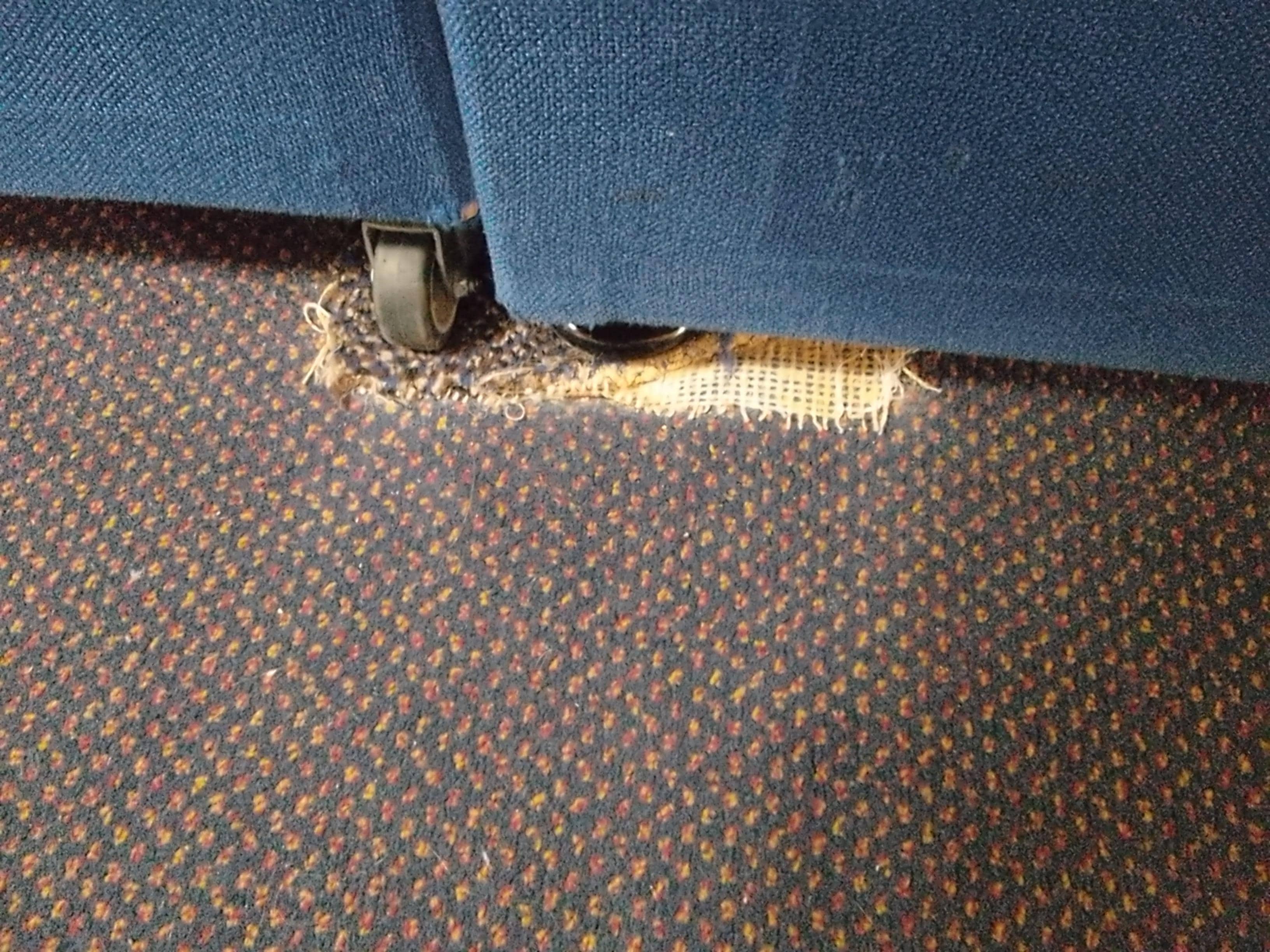 Worn carpet by thebed