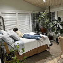 Lots of plants and windows with views to farm.