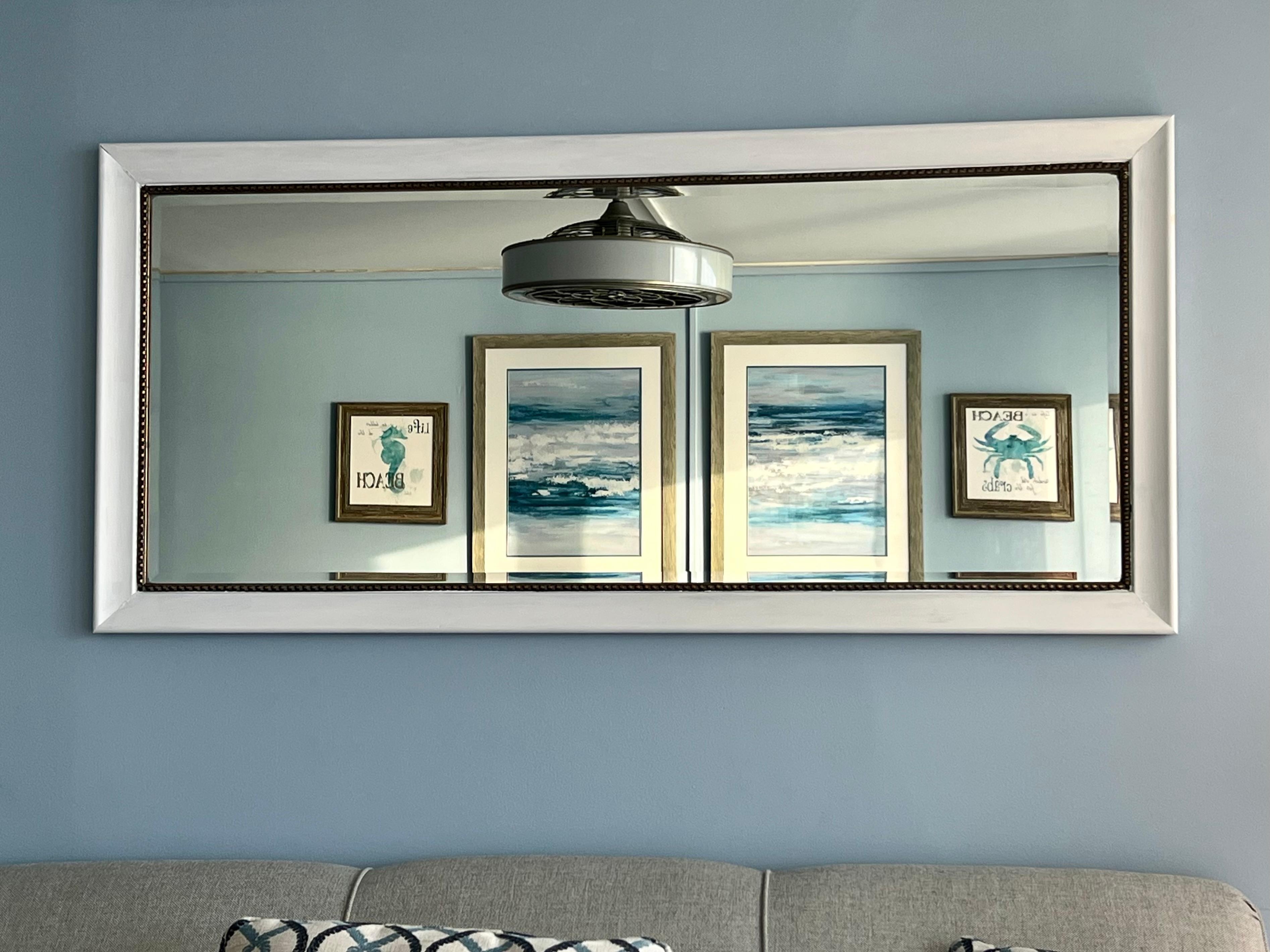 Lovely beveled mirror over sofa reflection artwork on opposite wall