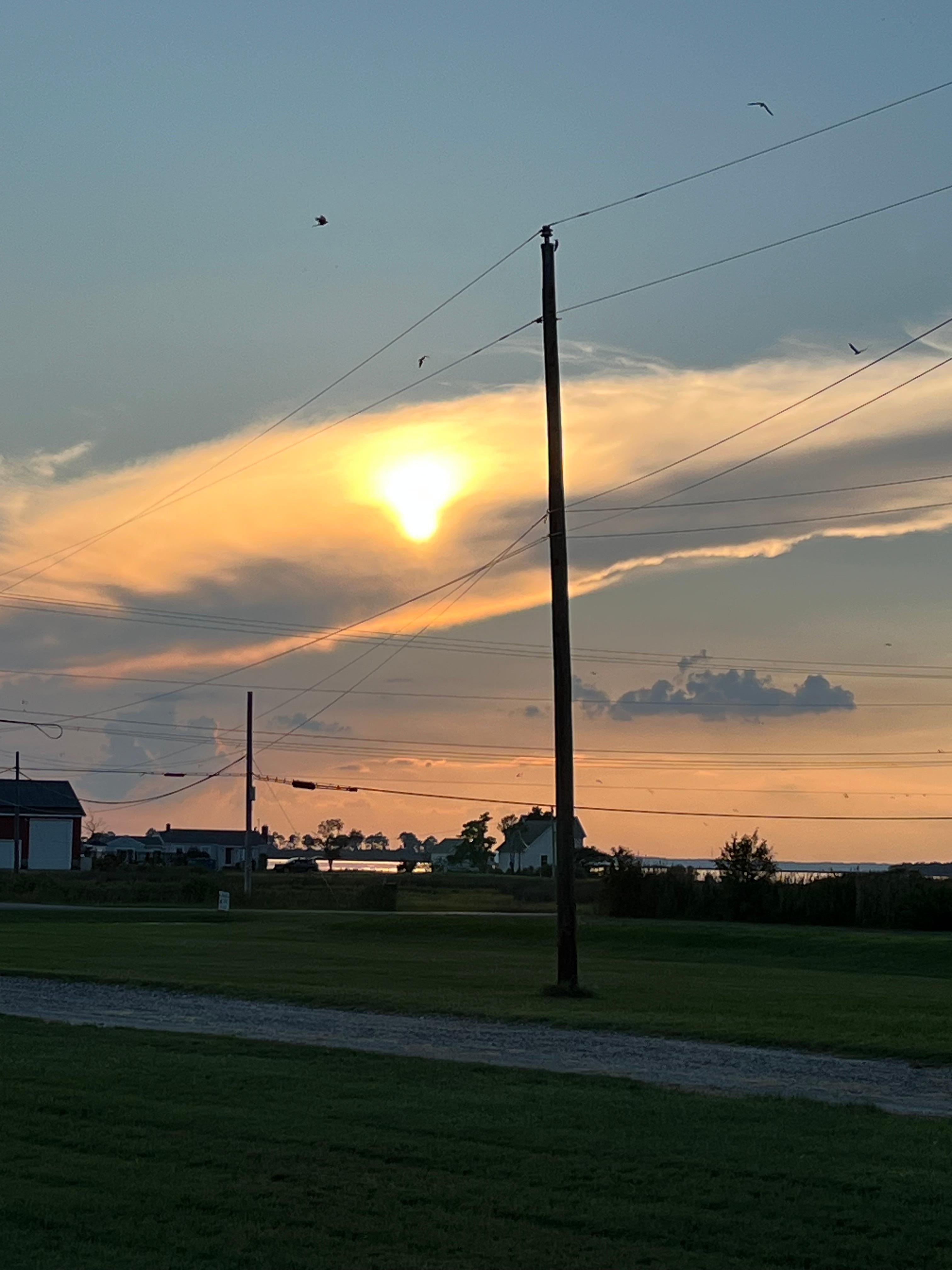 Clouds and sun setting