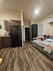 Living room, you can see stackable washer/dryer. Comfy twin bed!