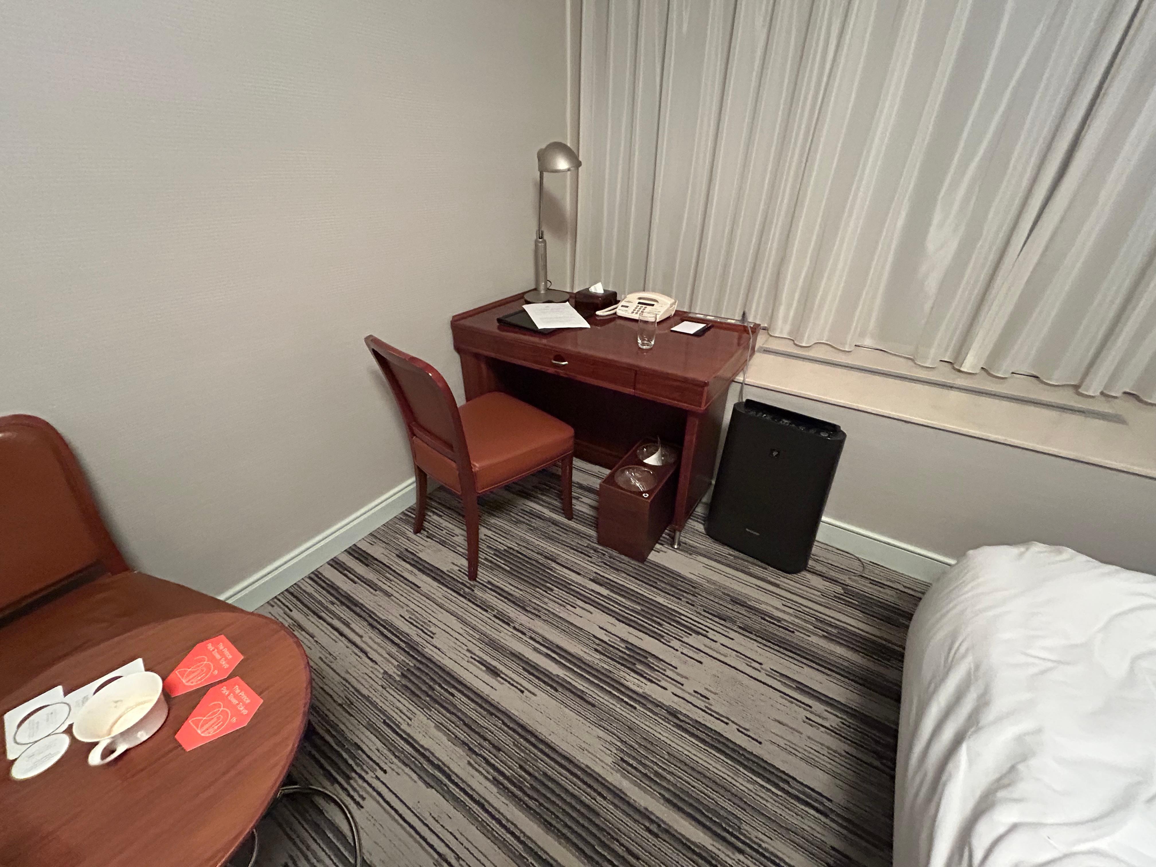 Small desk again with no modern needs like 3 prong outlets or USB. Same dated phone and furniture decor and a very simple chair. 