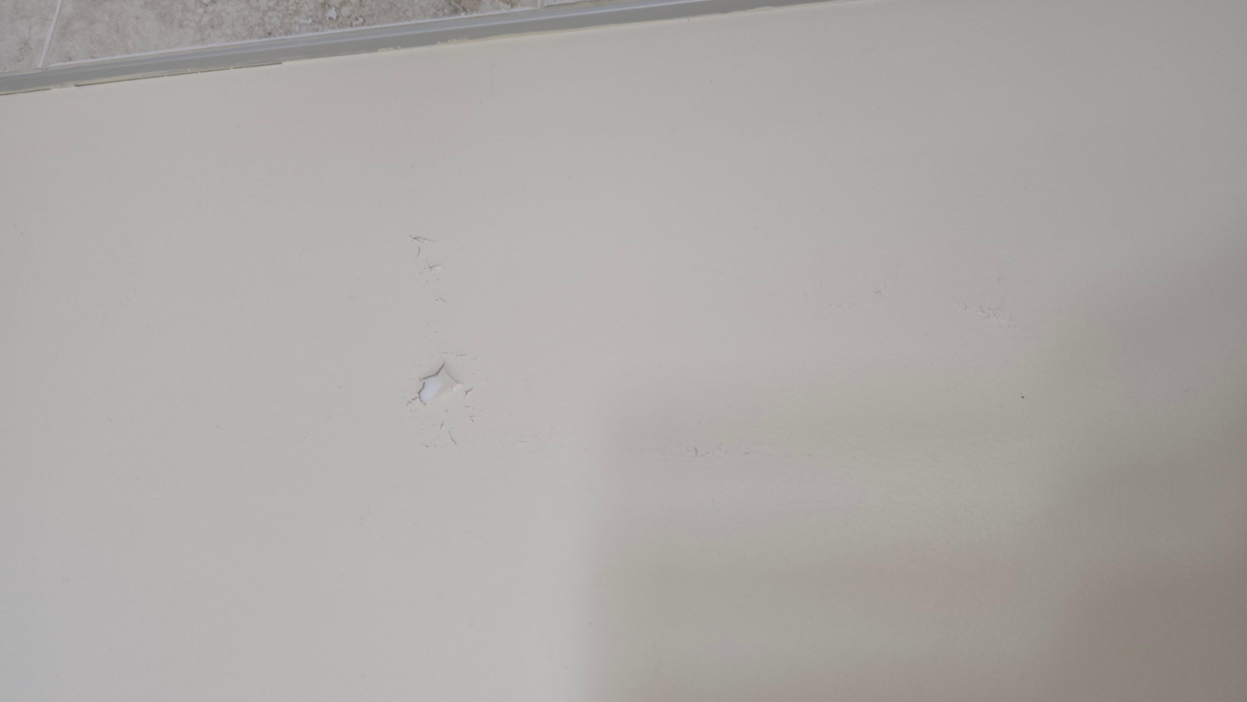Hole in wall. I have video of sink not draining that I couldn't add.
