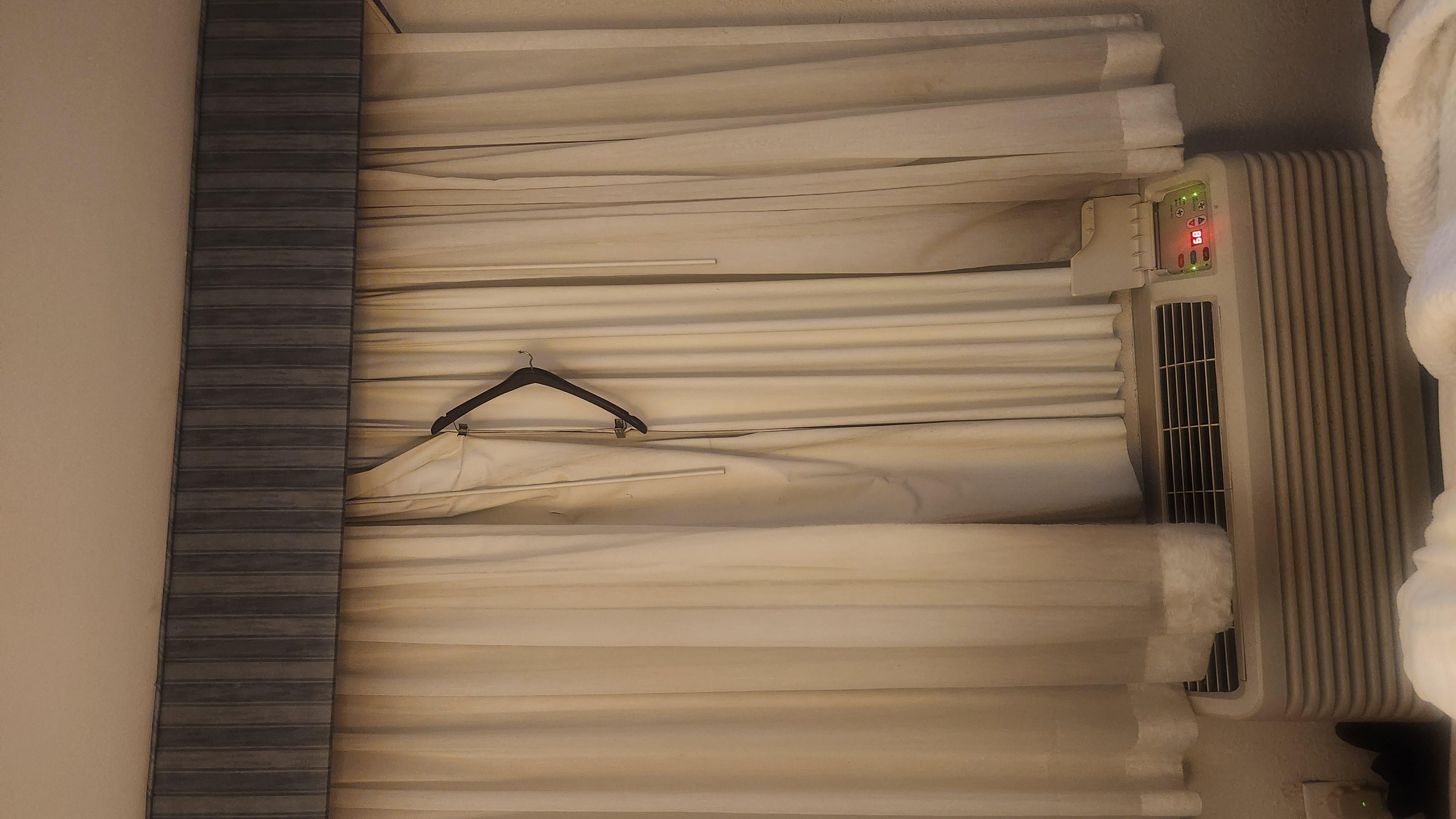 Someone left a hanger on the curtains to keep them shut . . .