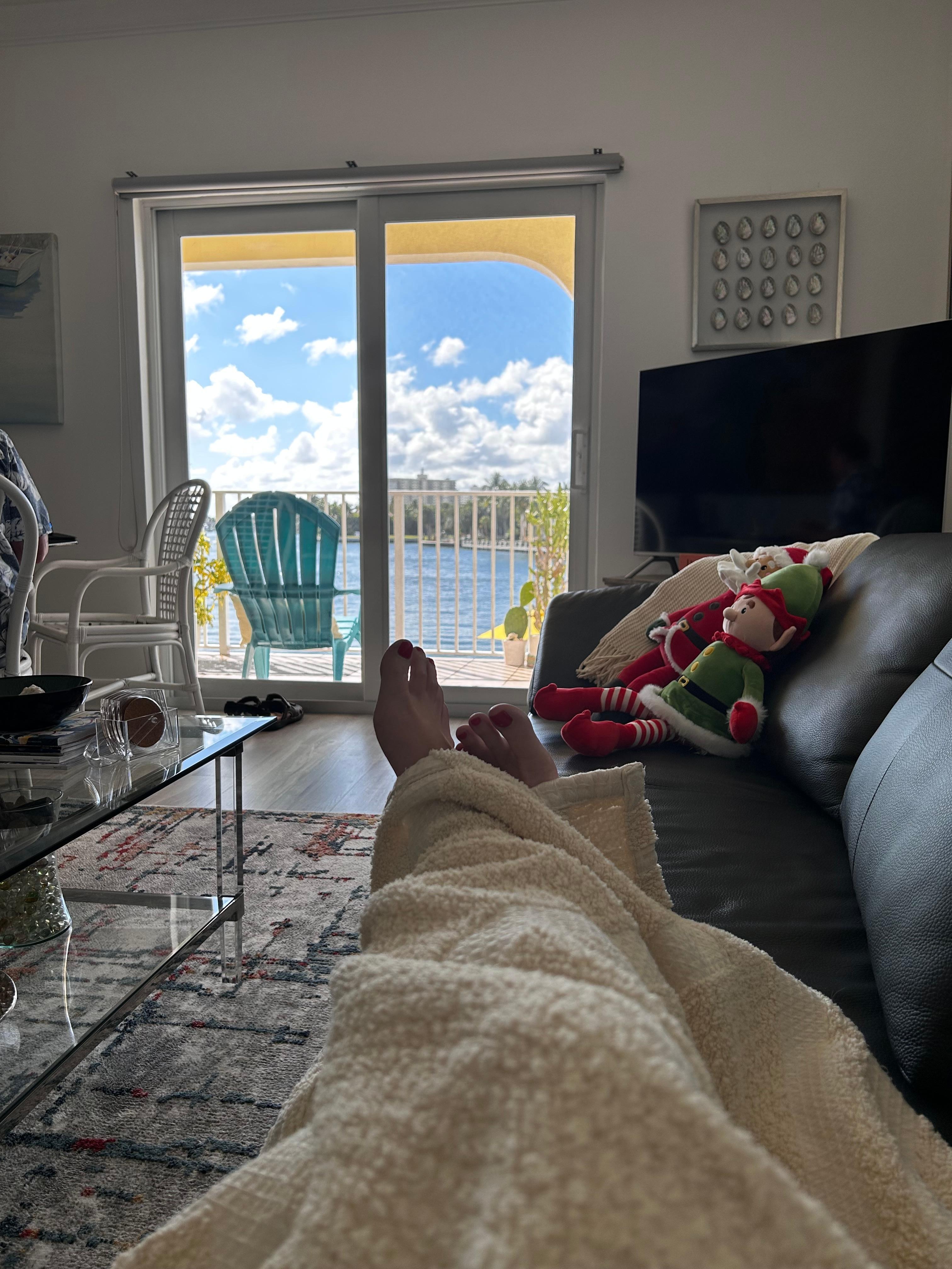 Relaxing on couch enjoying the deck view.