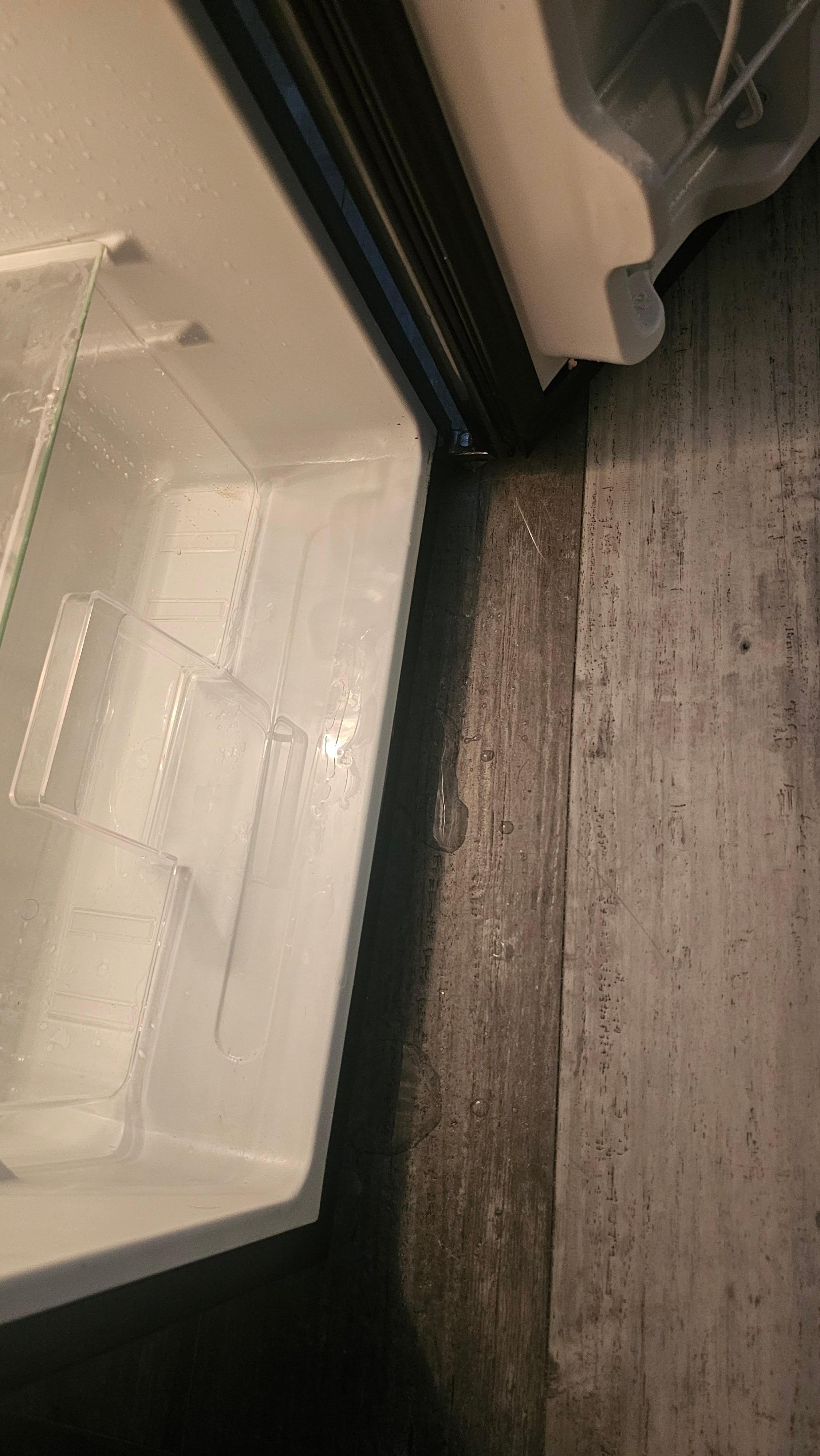 Water pouring out the fridge. 