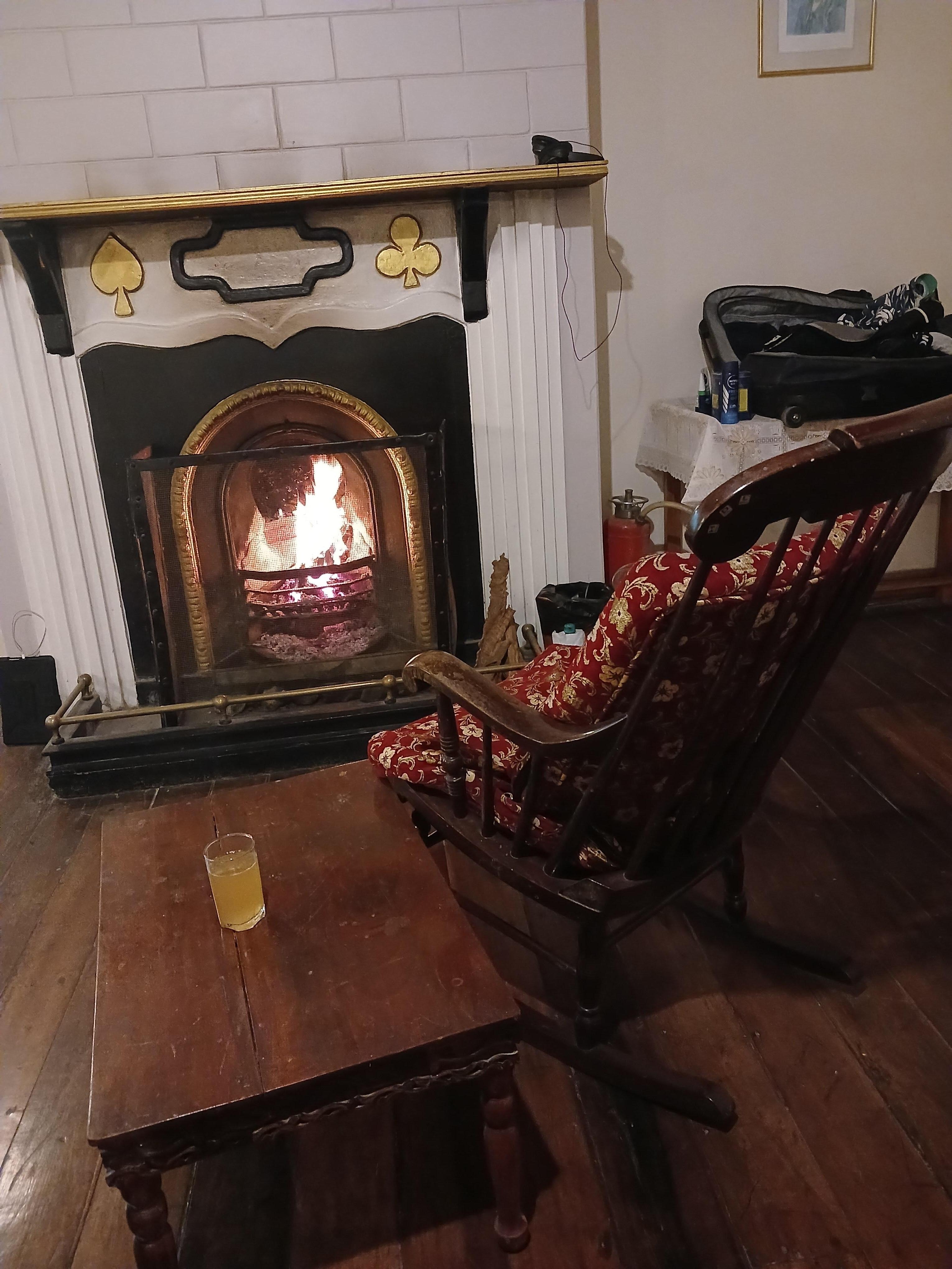 Slumped in front of a fire after hard trek in the hills