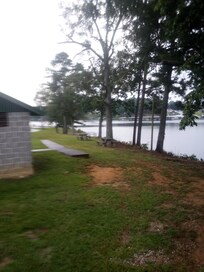 View from front porch showing walkway by restroom to fishing peer & boat launch area.