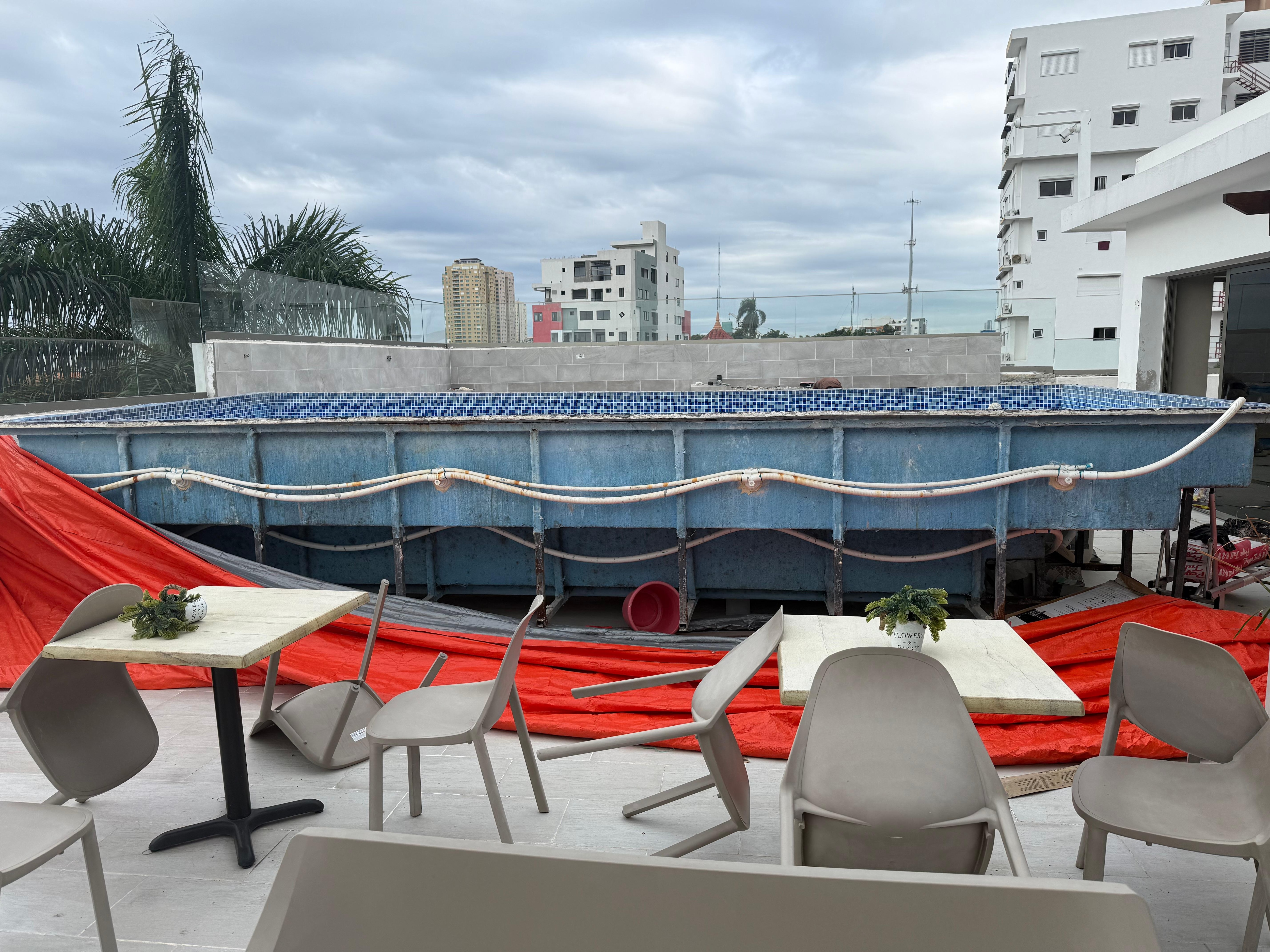 Same day. Still not finished 12 days later, but had been moved into the back corner and outer decking and stairs were being added with fake wood slats.