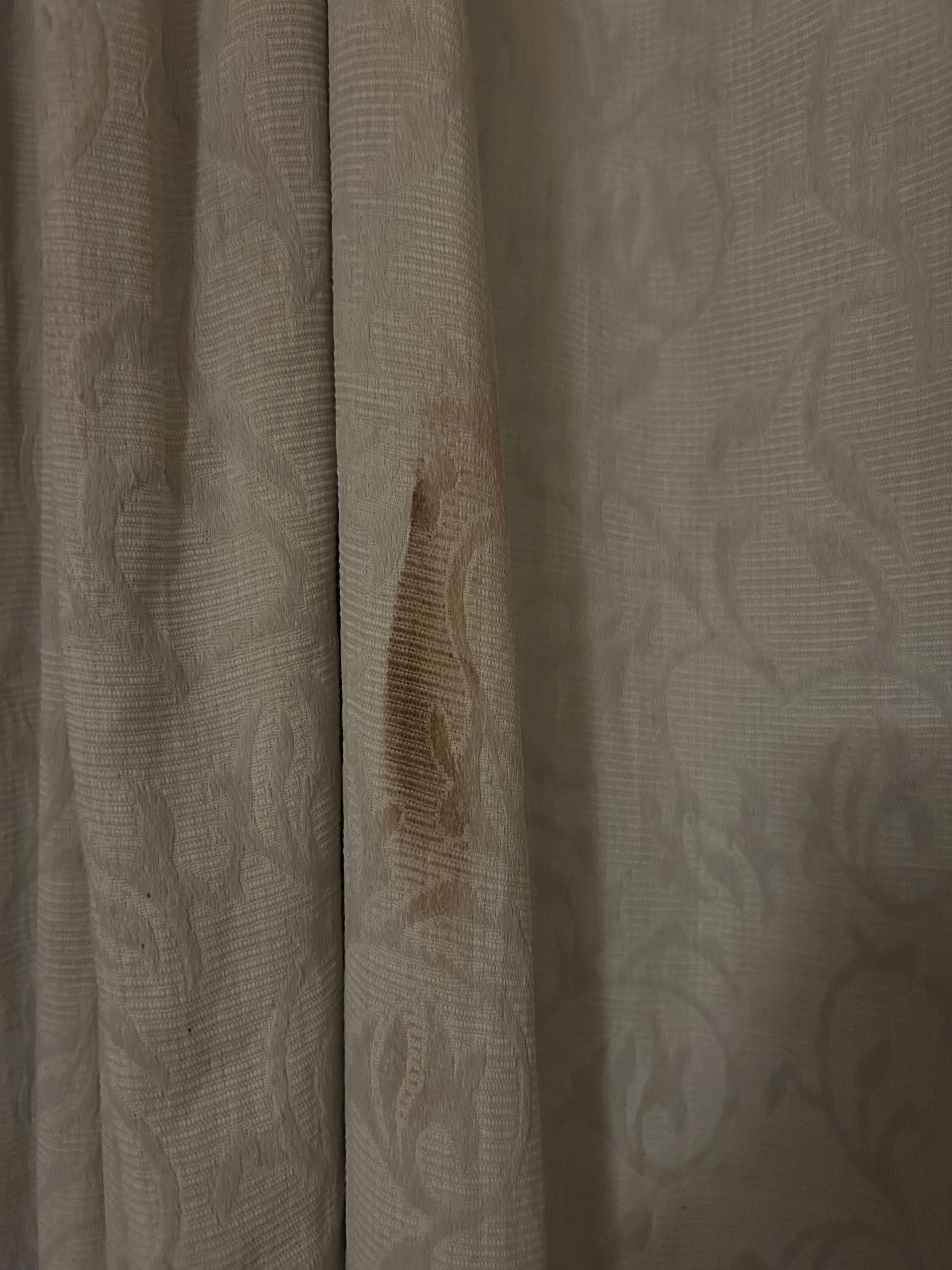 Stained and dirty curtains in our room.