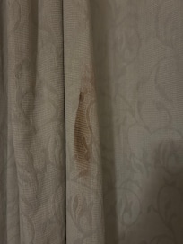 Stained and dirty curtains in our room.