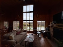 Huge windows overlooking the valley and pond.