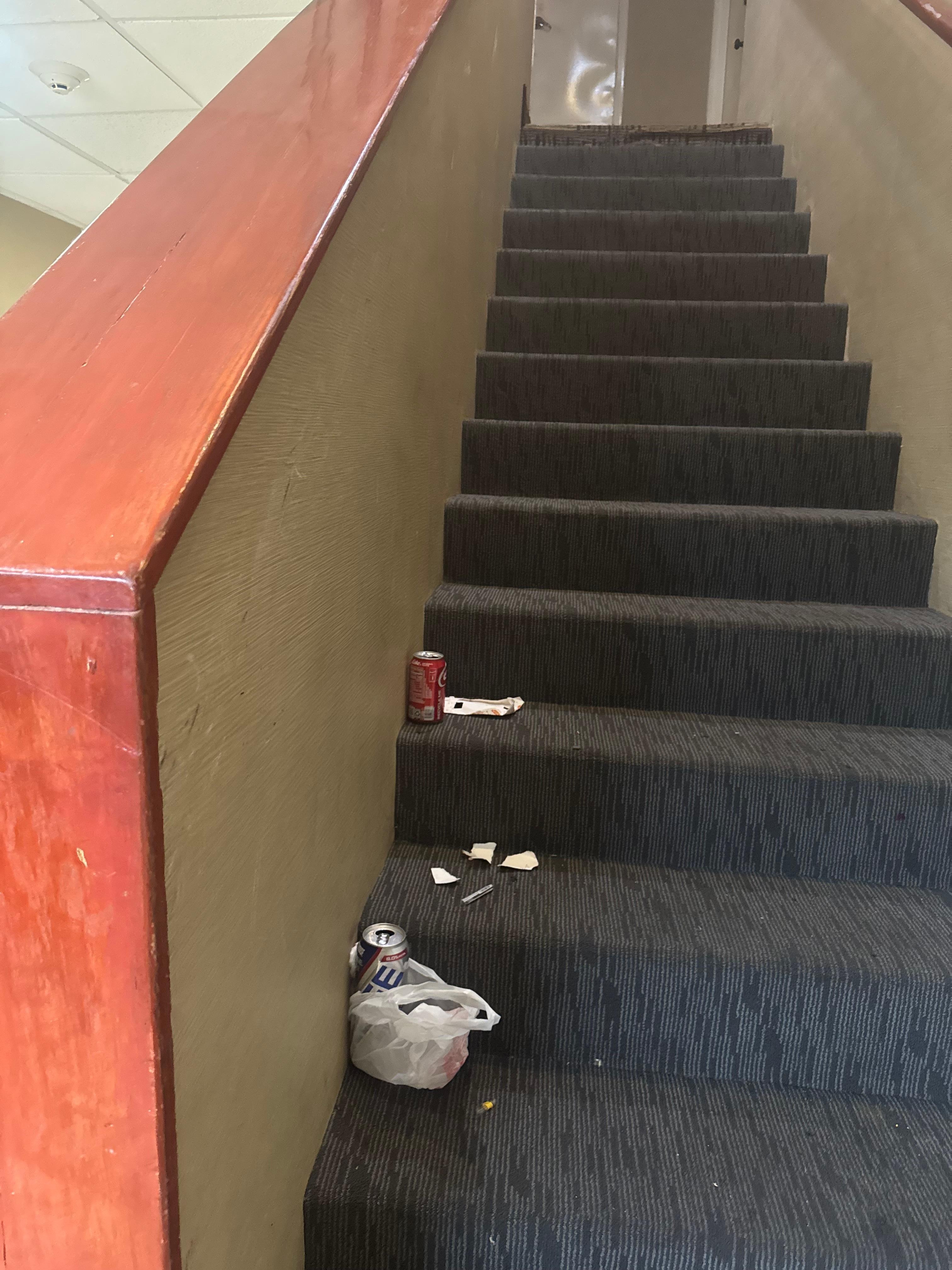 Open beer can and trash 