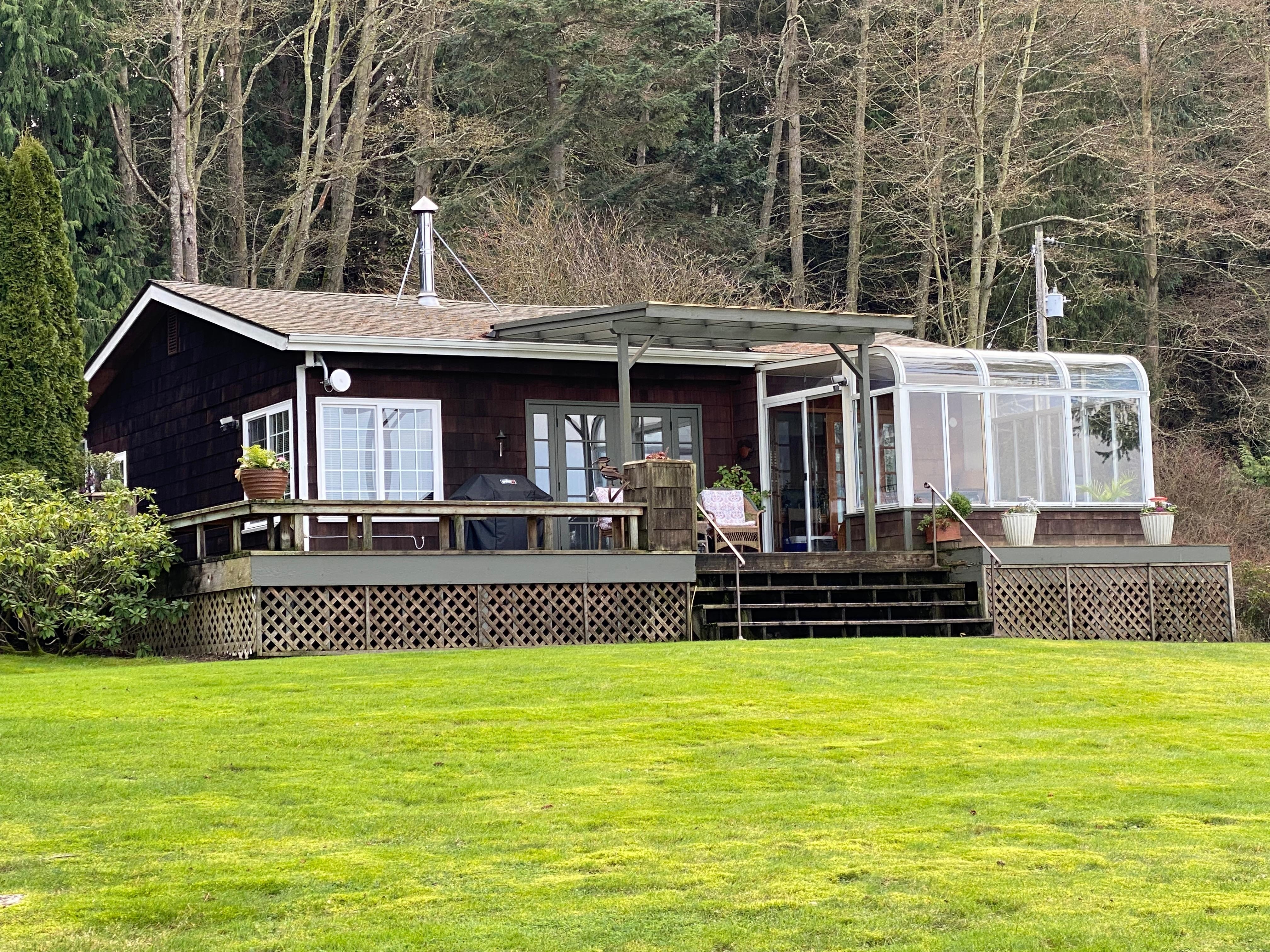 View of house from yard next to waterfront 