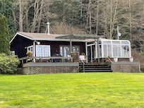 View of house from yard next to waterfront