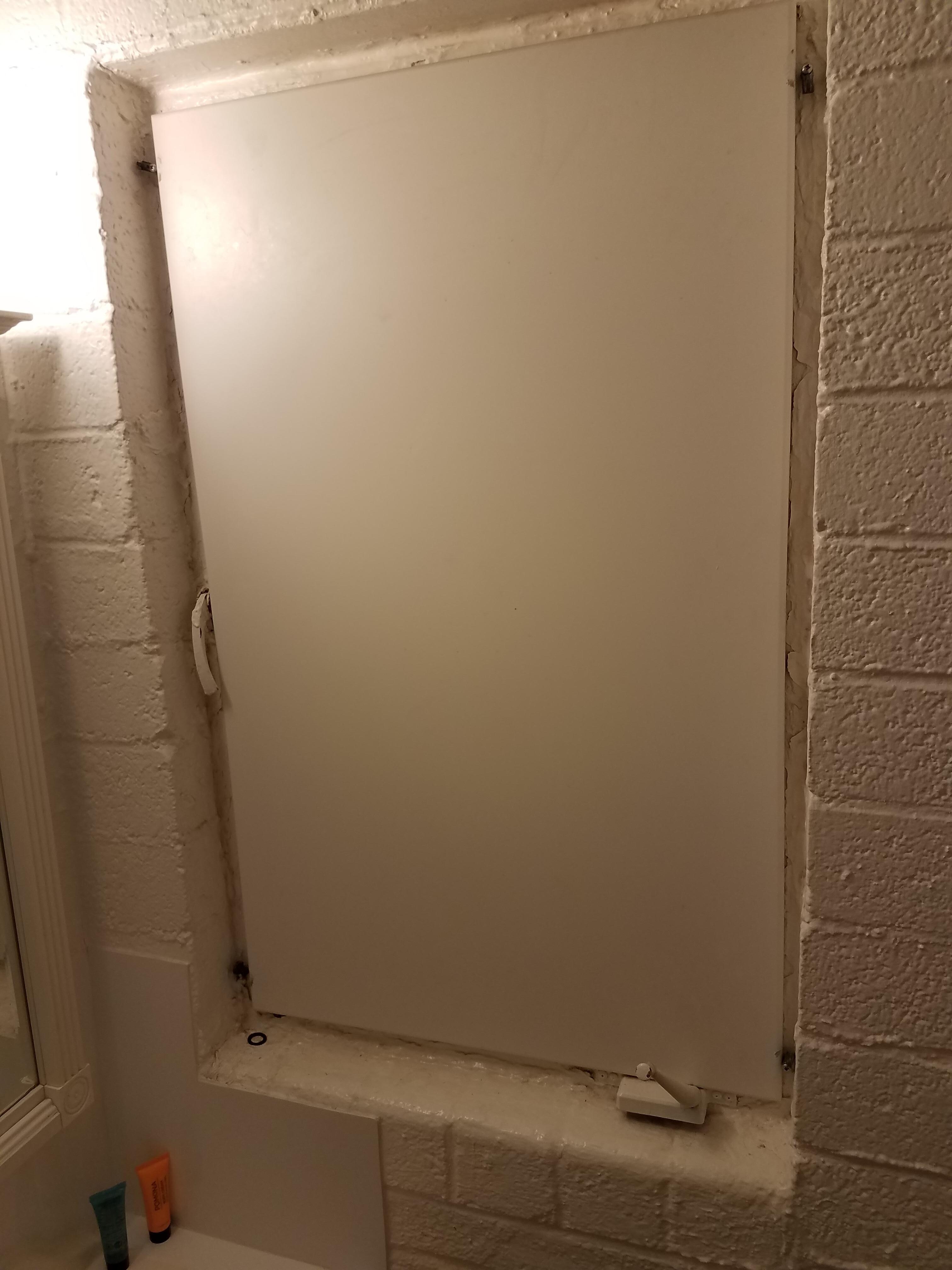 Board over window in bathroom