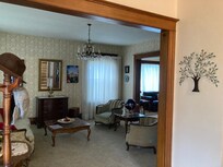 Large living room with comfy furniture and lots of books
