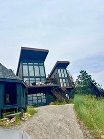 Steep driveway up to cabin, L side is “main” cabin and R side is bedroom only.