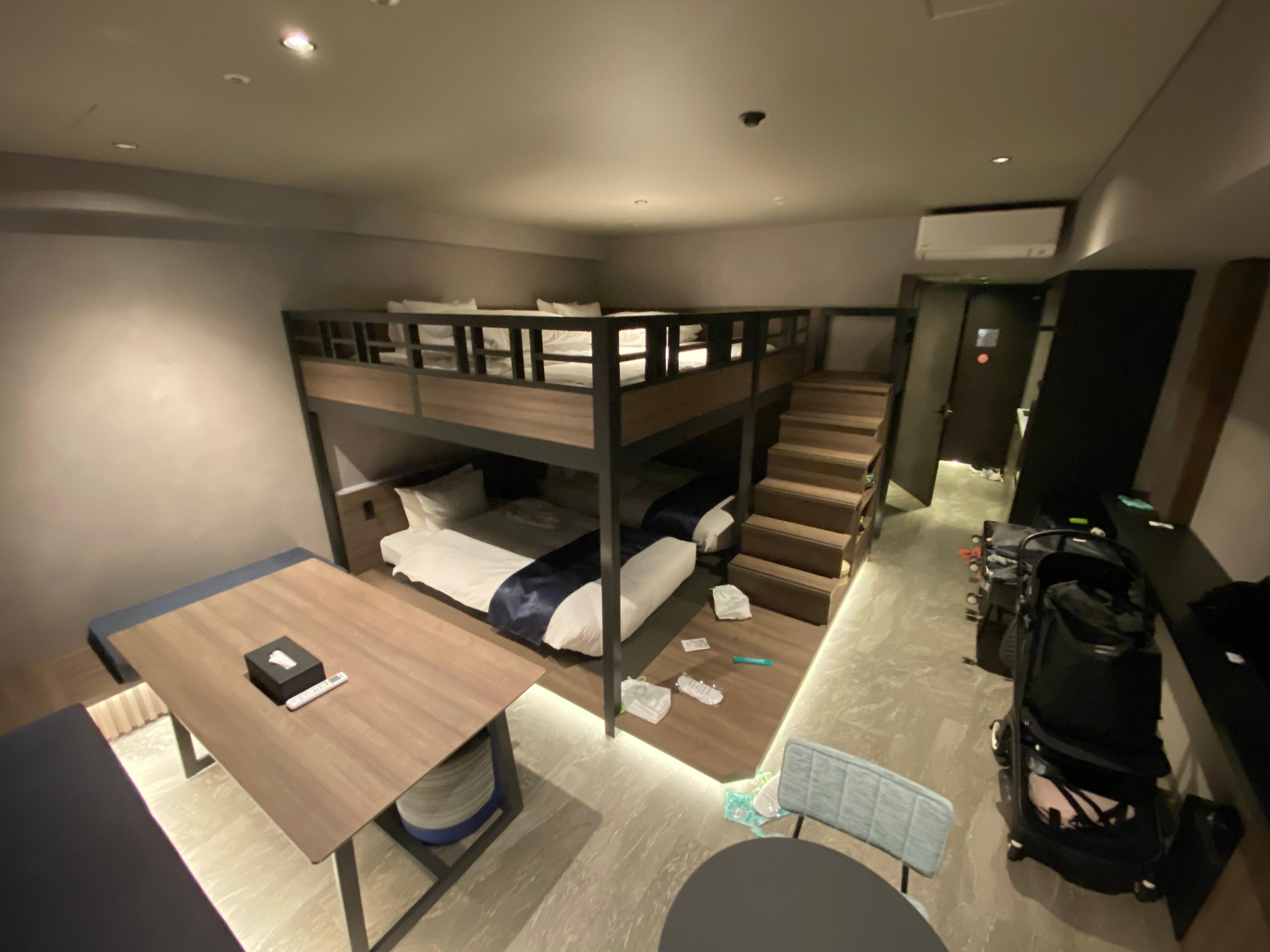 Wide view of bedroom bunk beds and living area